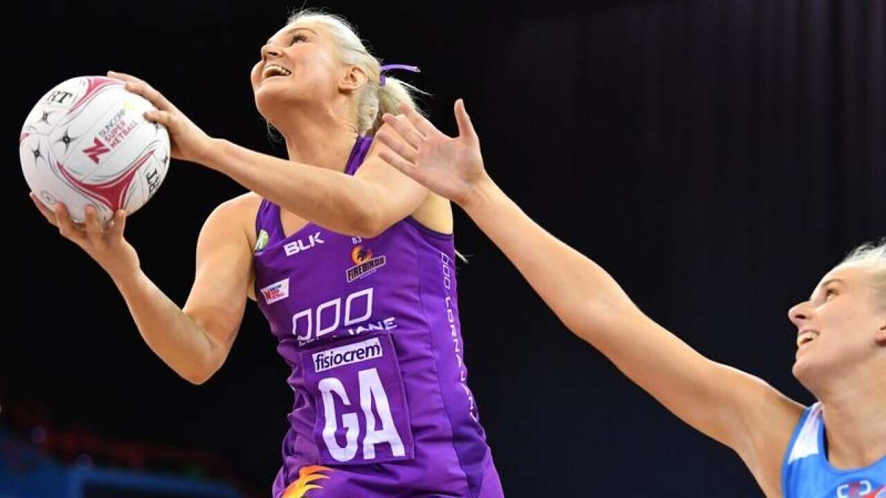 Gretel Tippett of the Firebirds grabs the ball.