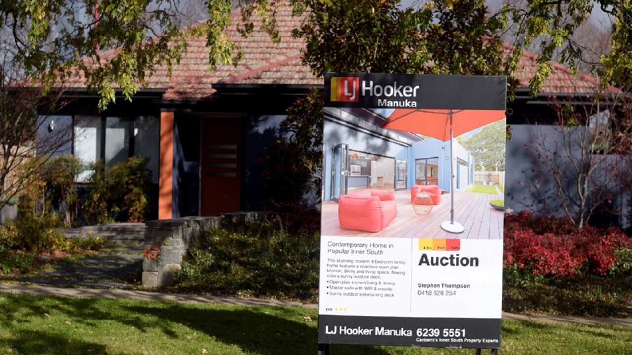 An auction sign outside a house in Canberra