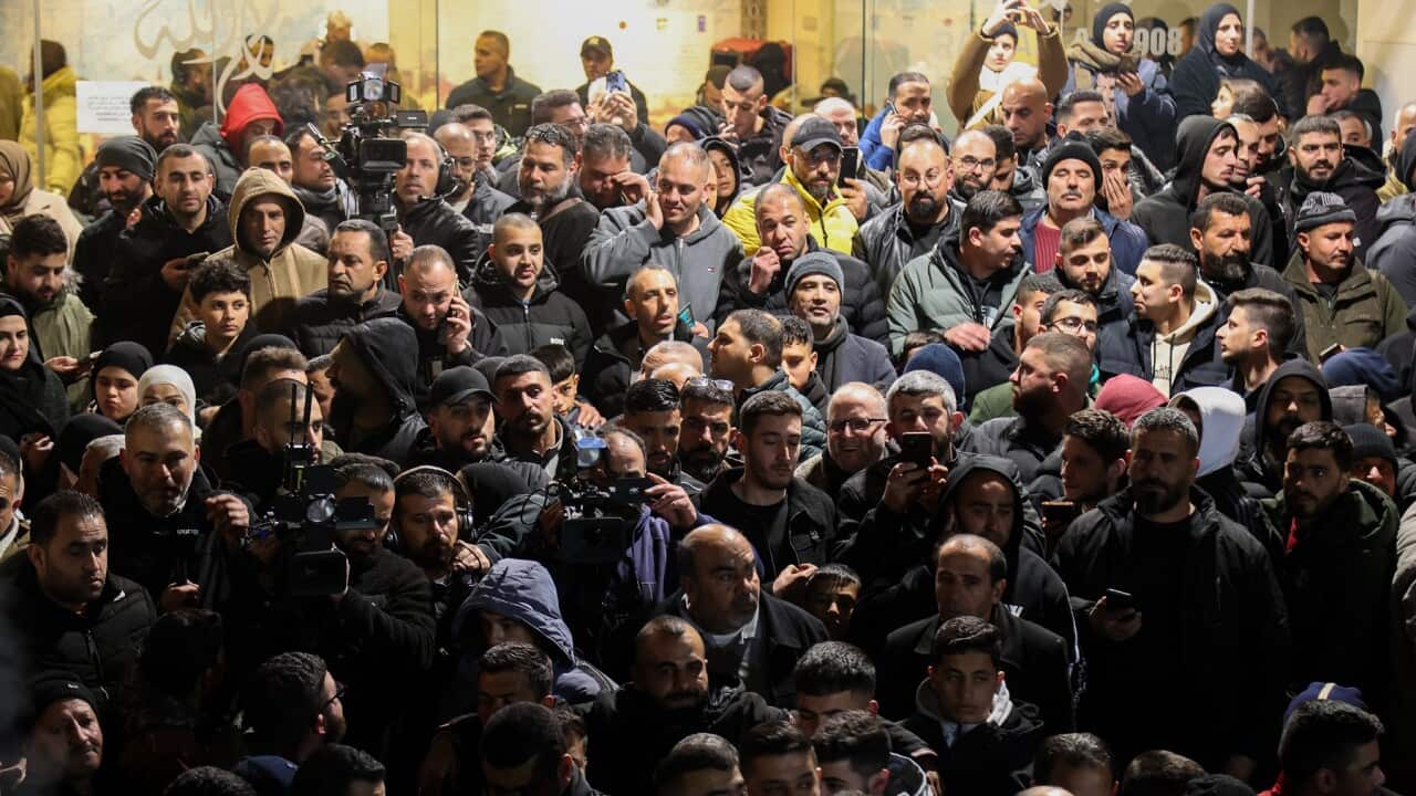People and media members gather to welcome Palestinians released from Israel's prisons (AAP)k