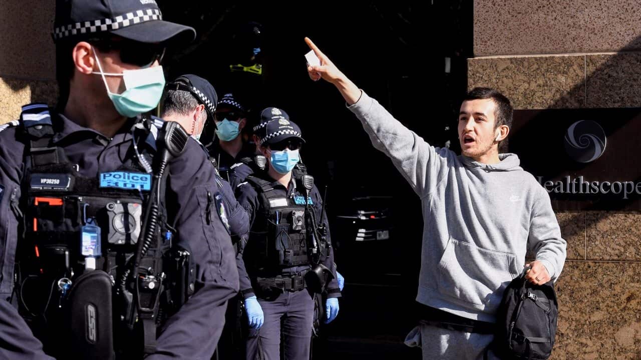 An anti-mask protester shouts at police in Melbourne