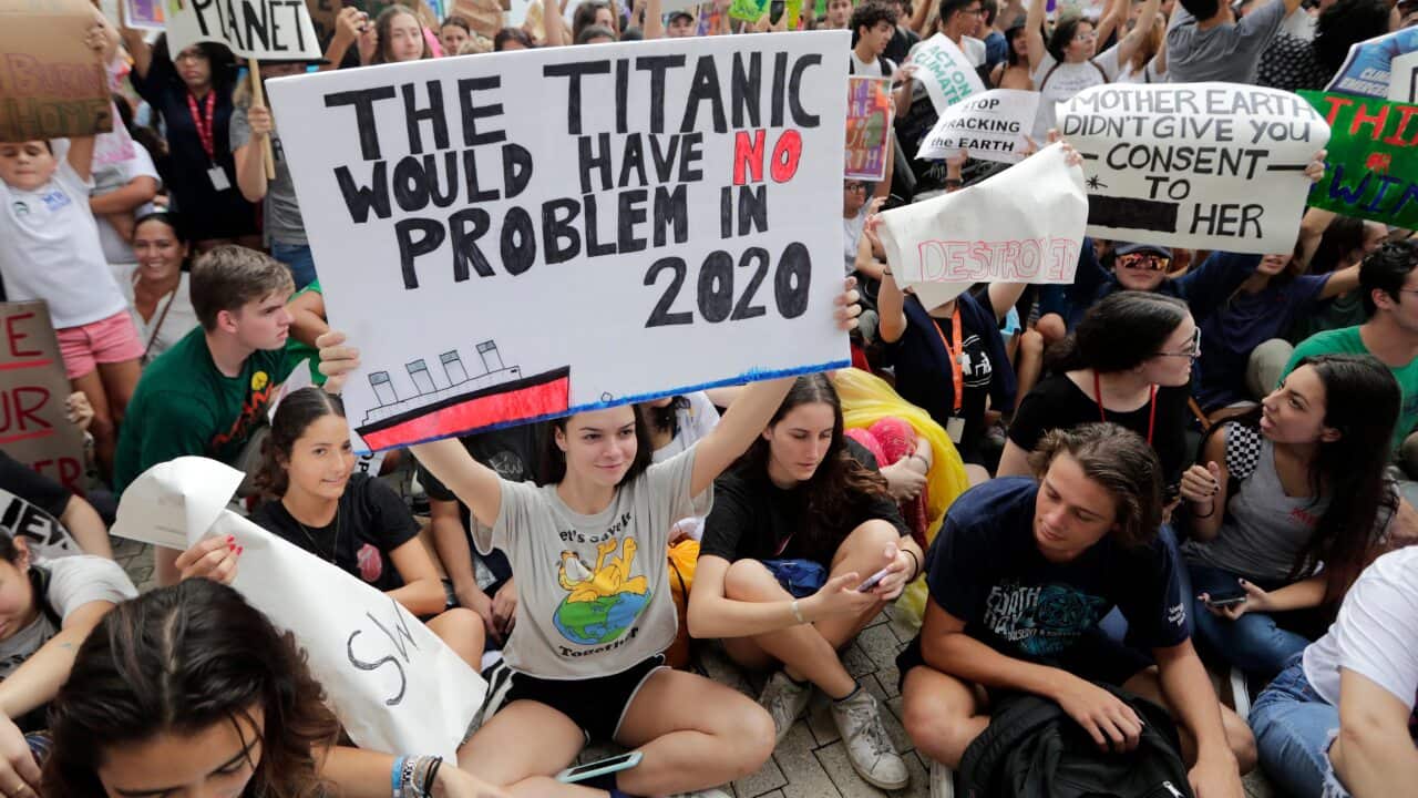 Students hold signs during a protest organized by the U.S. Youth Climate Strike outside of Miami Beach City Hall, as part of a global day of climate action, Friday, Sept. 20, 2019, in Miami Beach, Fla. (AP Photo/Lynne Sladky)