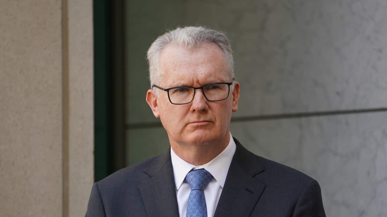 A man listening during a press conference.