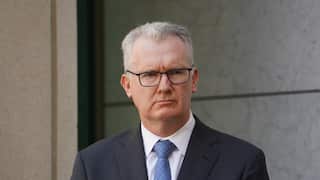 A man listening during a press conference.