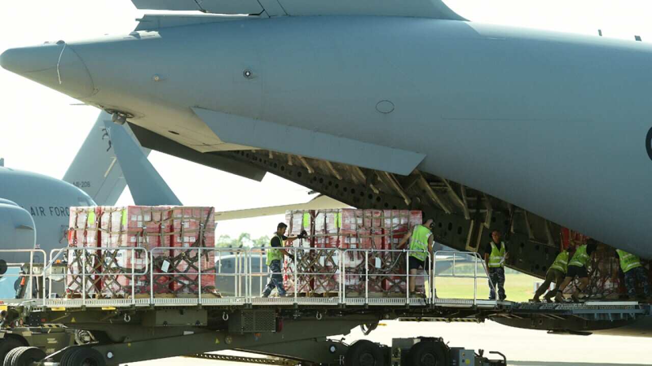 Aid is seen onboard an Australian RAAF C-17 Globemaster aircraft