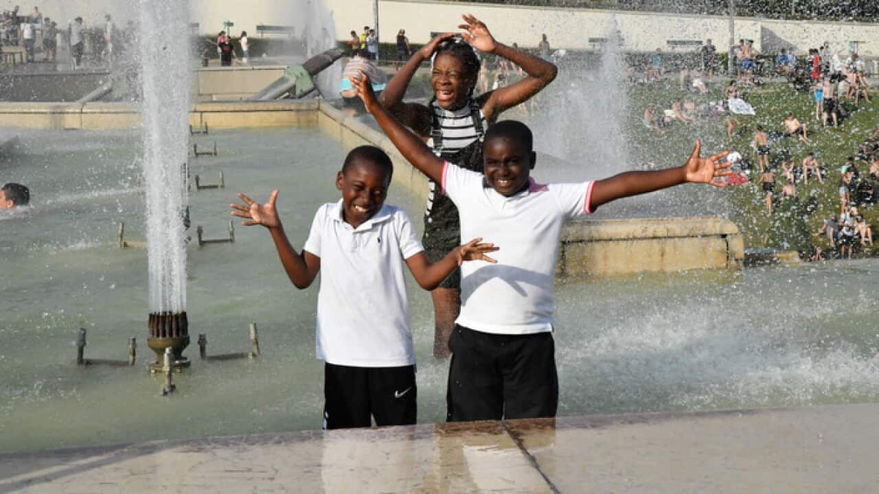 People cool off at the Trocadero Fountains in Paris, France, on July 25, 2019.