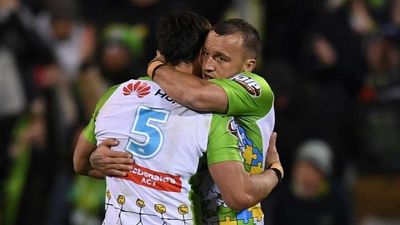 Canberra Raiders captain Josh Hodgson (R)