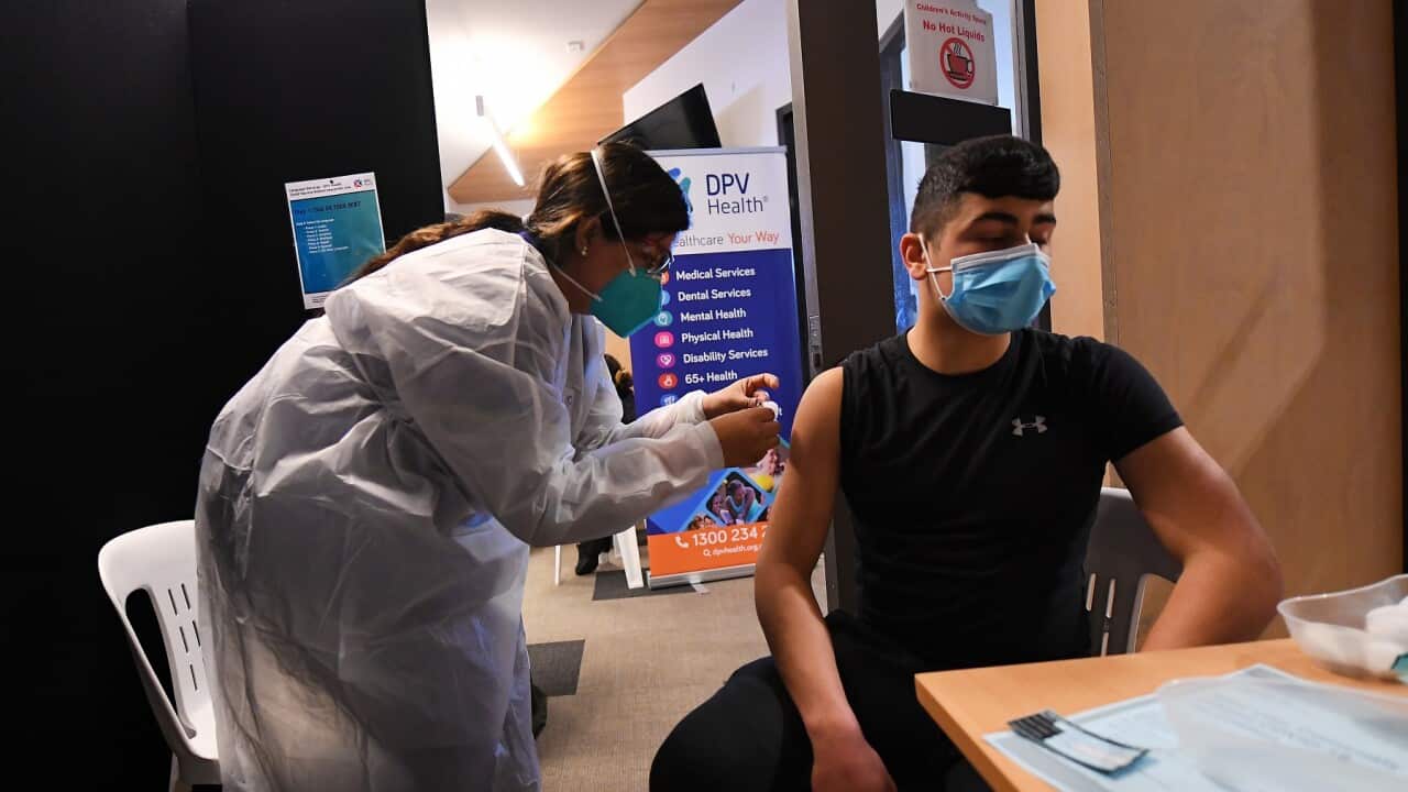 Healthcare worker Simi Kandra (left) administers a Covid19 vaccine for Omar Khodr at a pop-up Covid19 vaccination clinic in Broadmeadows, Melbourne.