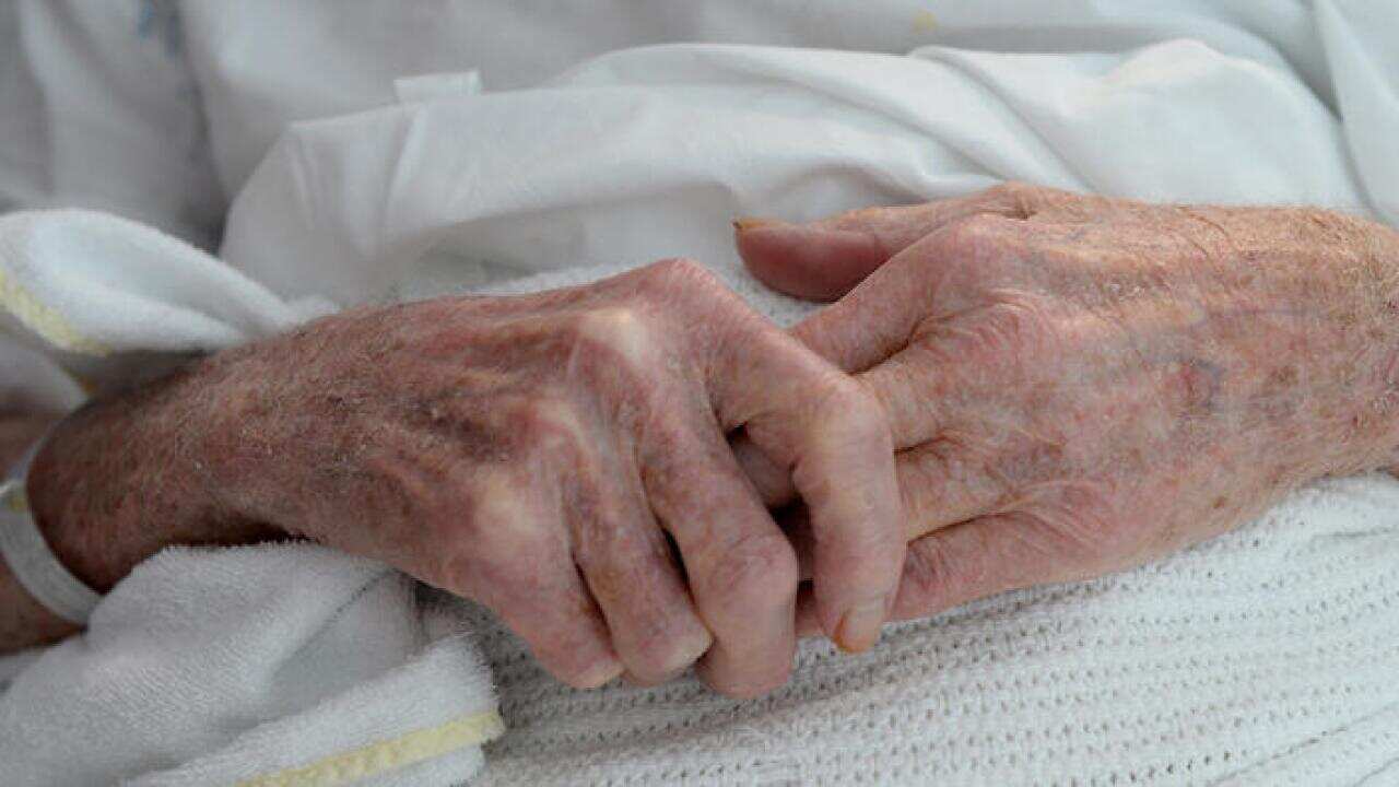 An elderly patient's hands with a hospital identification band at Liverpool Hospital, Sydney on Tuesday, June 11, 2013. (AAP Image/Dan Himbrechts) NO ARCHIVING