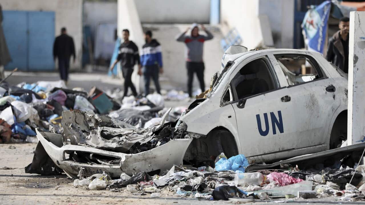Palestinians walk through the destruction left by the Israeli air and ground offensive on the Gaza Strip in Gaza City, Saturday, Feb. 10, 2024.