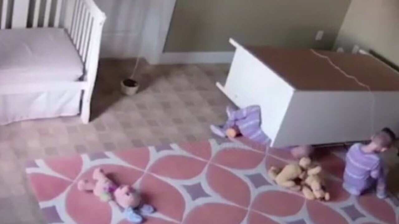 The incredible moment boy, two, shows fantastic strength and saves his twin brother from being crushed by a falling dresser.