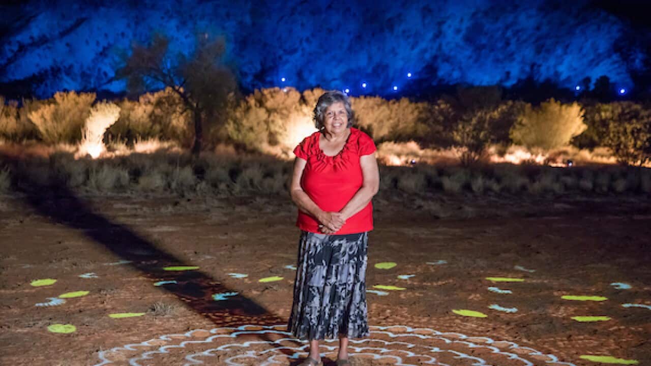 Parrtjima, a festival in Light, Alice Springs, 2017. Local artist Patricia Ansell Dodds with her artwork from the installation Grounded. September 21.