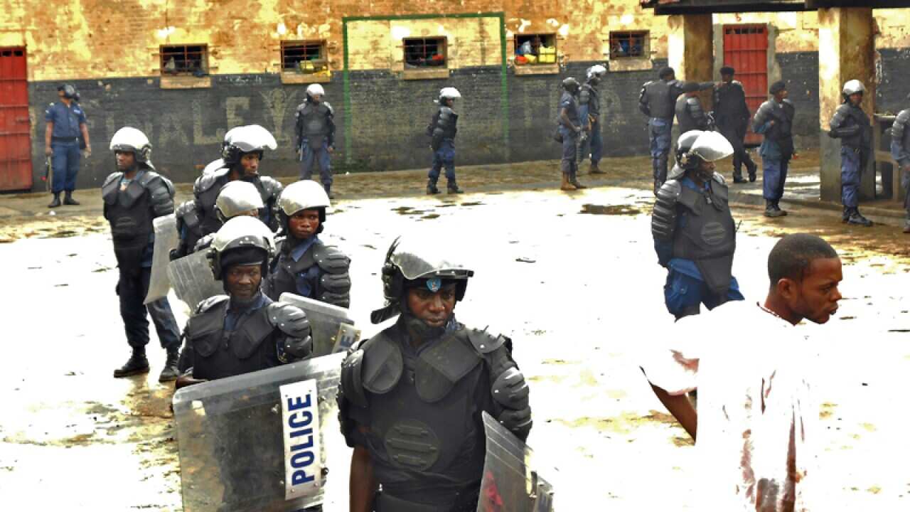 Congolese police officers stand guard in a prison in Bukavu