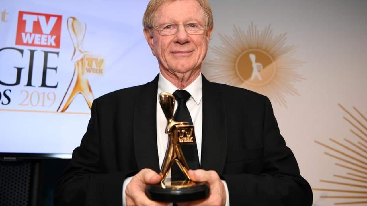 Veteran journalist Kerry O'Brien poses with his Logie.