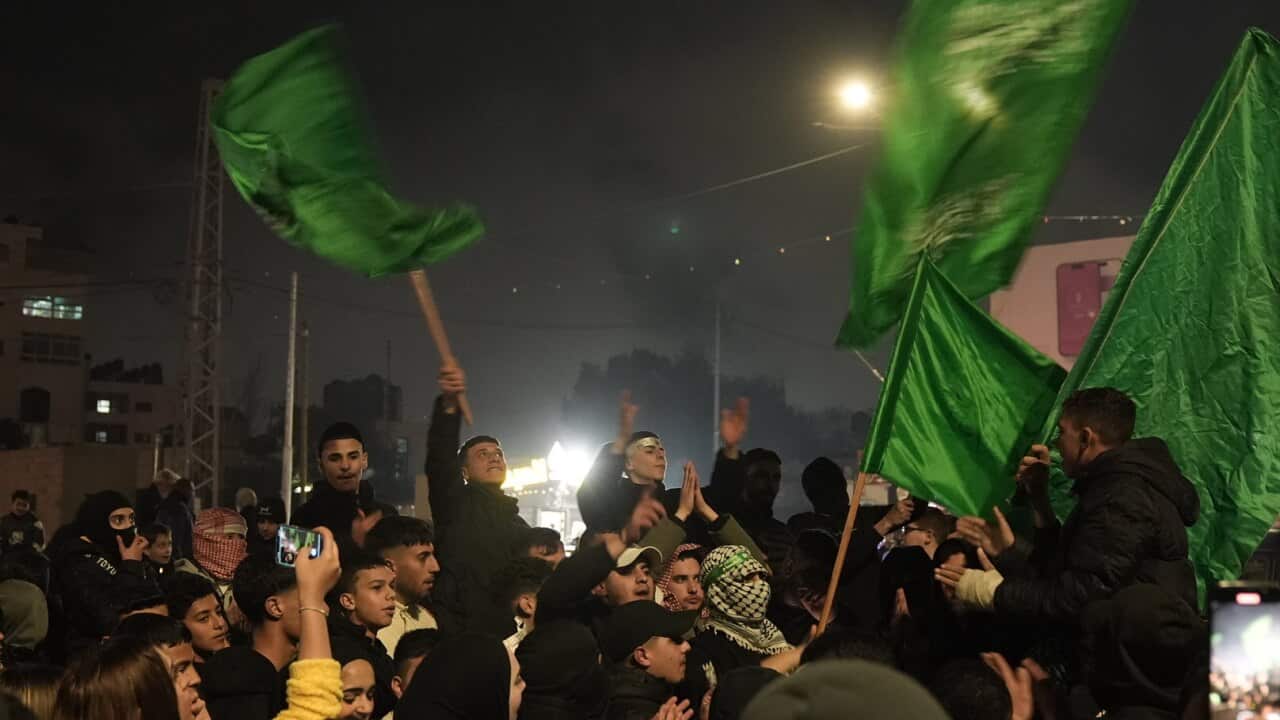People celebrating waving green flags