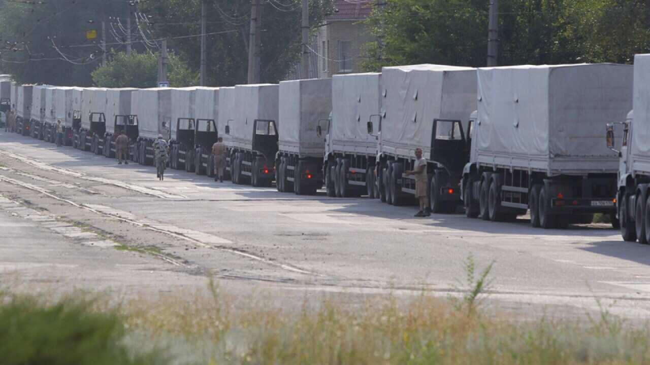 Drivers of the first trucks of the Russian aid parked in the Ukraine