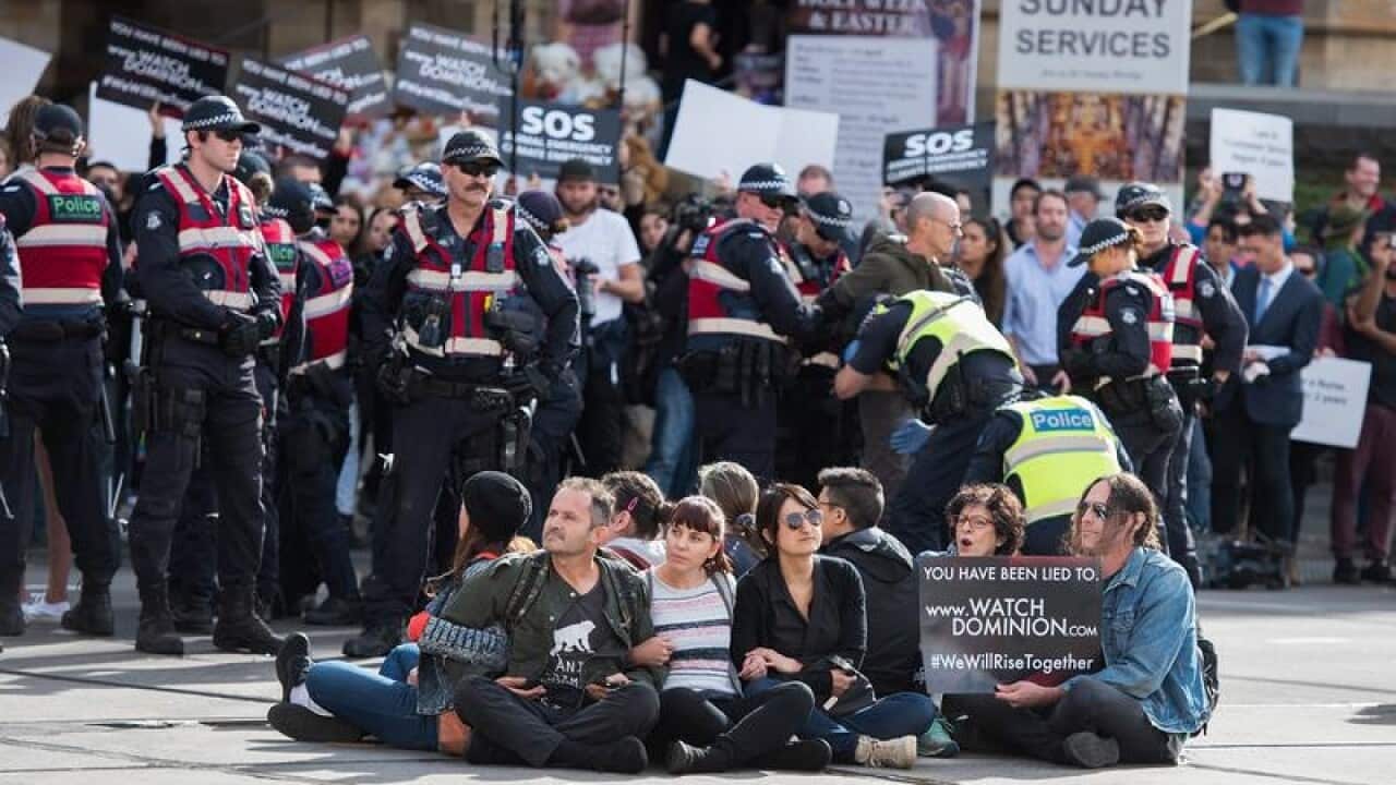 Animal rights protesters were arrested after blocking a major Melbourne CBD intersection.