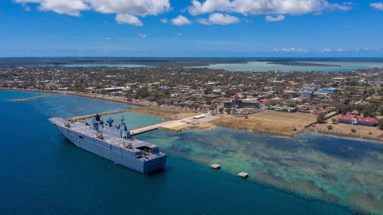 Ship docks in ocean near island port
