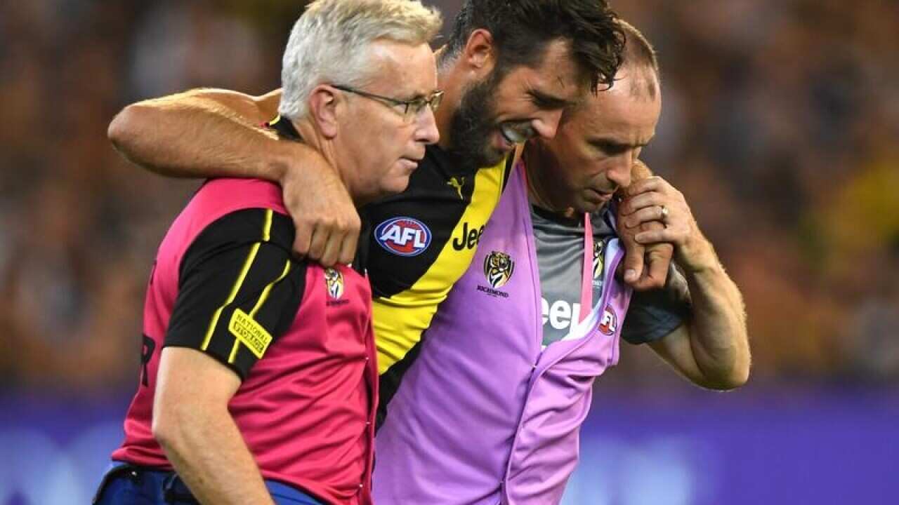 Alex Rance of the Tigers (centre).