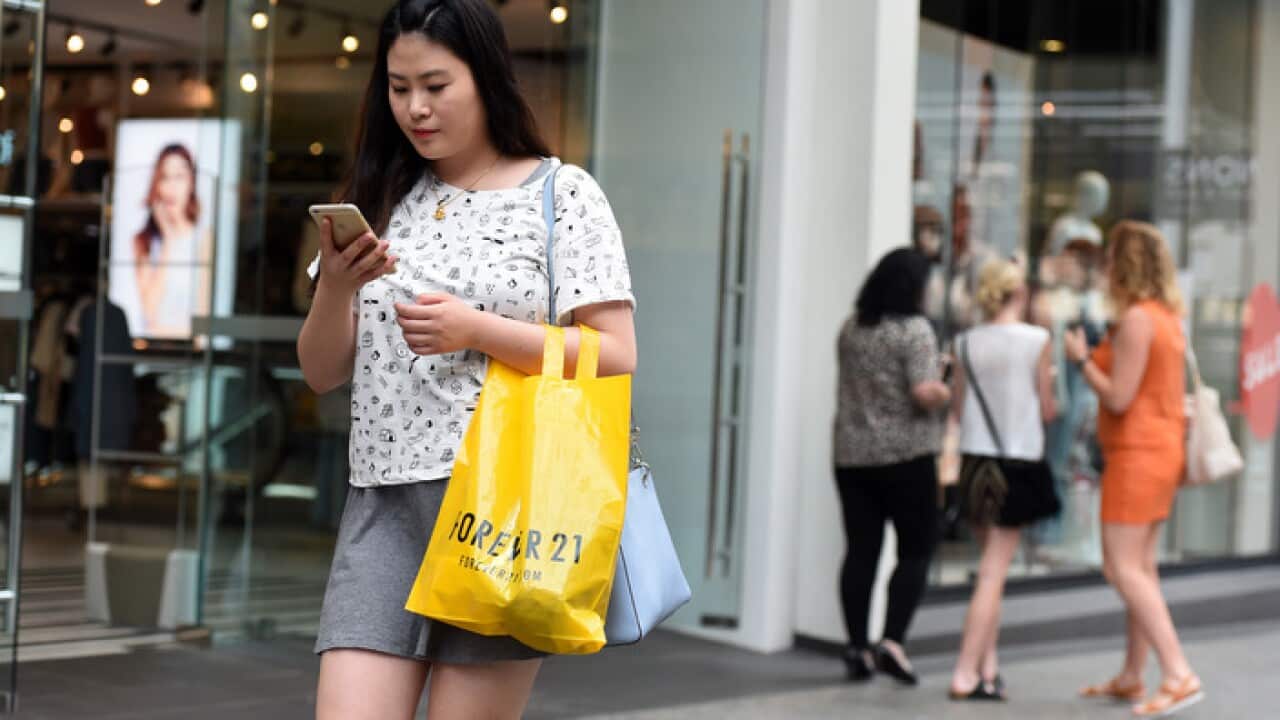 Shoppers walk through Queen Street mall in Brisbane