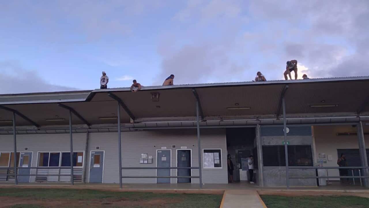 Detainees are shown on a roof at Christmas Island on Tuesday.