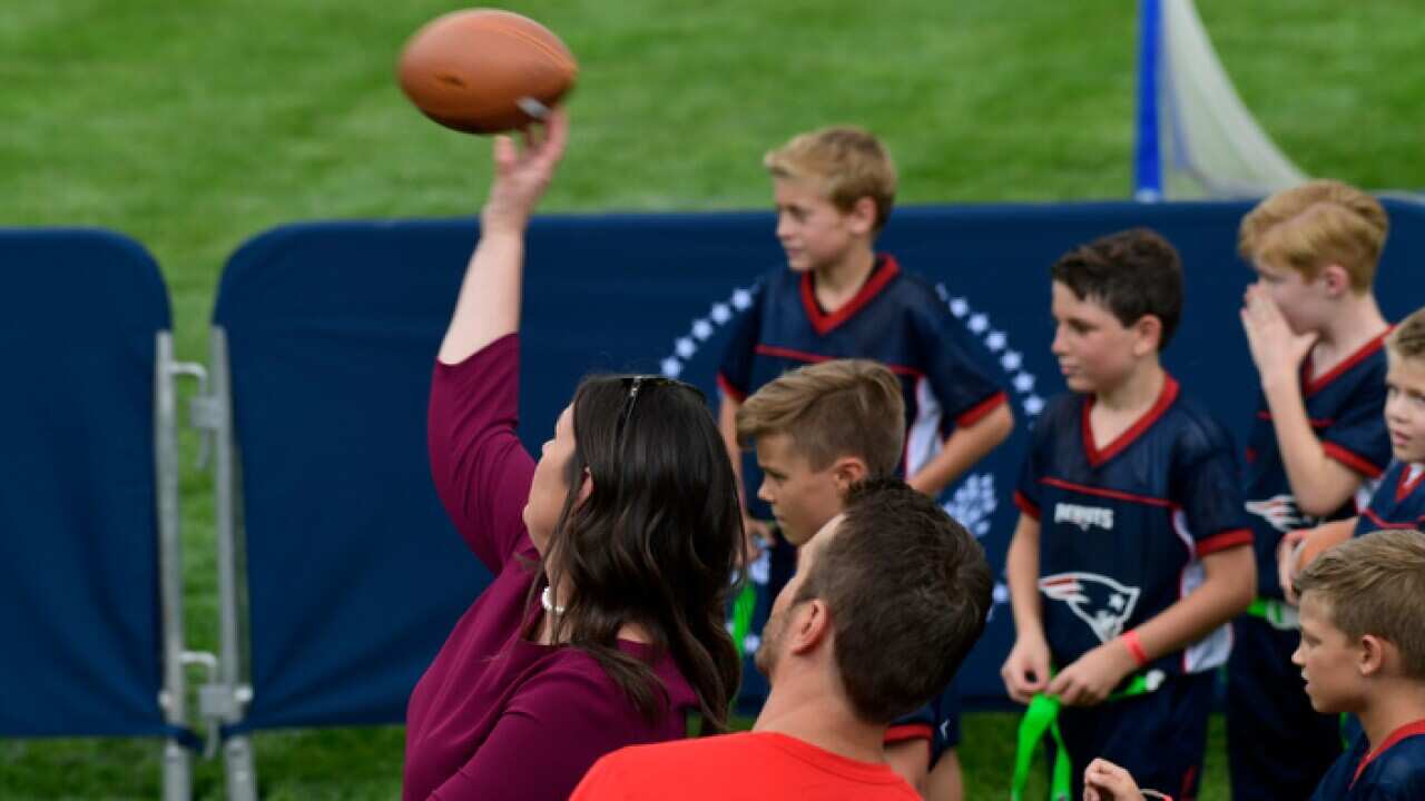 Sarah Huckabee Sanders throws a football with kids at the White House