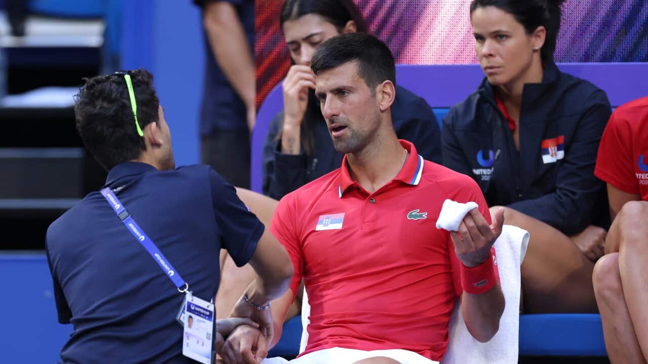 Novak Djokovic of Serbia receives medical attention to his wrist during his match against Alex De Minaur of Australia during their quarterfinal match of the 2024 United Cup at RAC Arena in Perth