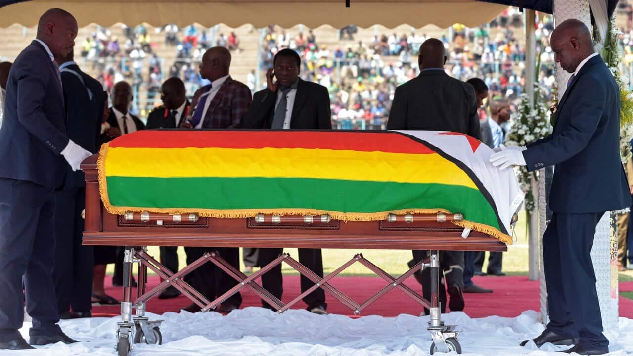The coffin of late former Zimbabwean president Robert Mugabe is put on display during a public funeral parade in Harare, Zimbabwe.