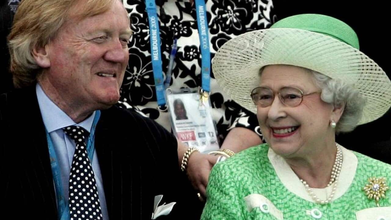 Queen Elizabeth II smiles as she chats with Ron Walker.