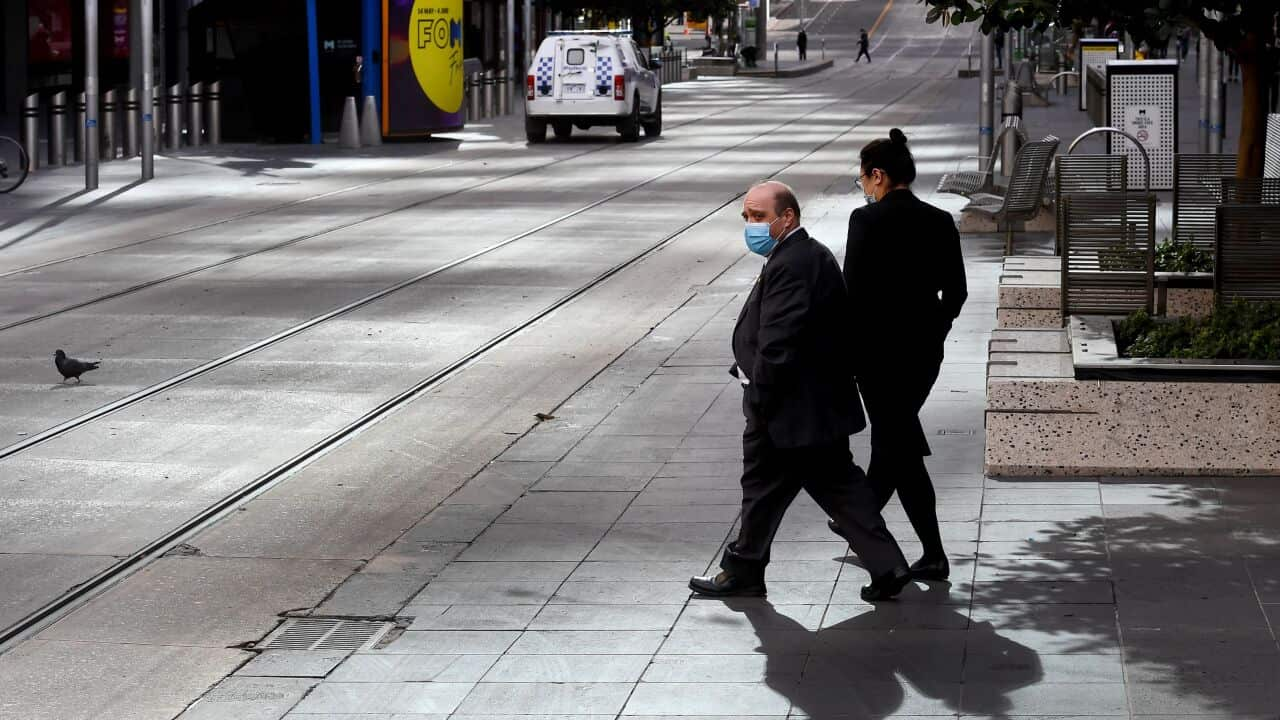 People cross Melbourne's normally bustling Bourke Street Mall during lockdown on 4 June, 2021.