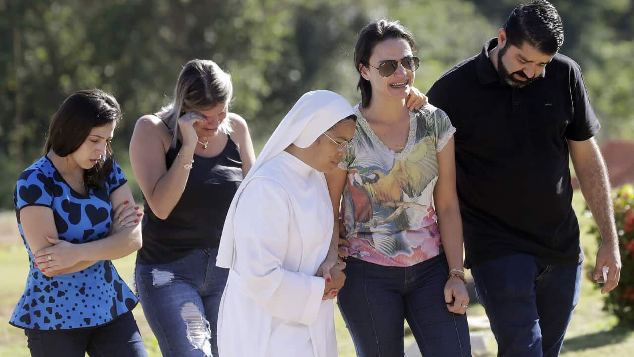Friends and relatives attend the burial of Vale SA employee Edgar Carvalho Santos, victim of the collapsed dam in Brumadinho, Brazil, Tuesday, Jan. 29, 2019.
