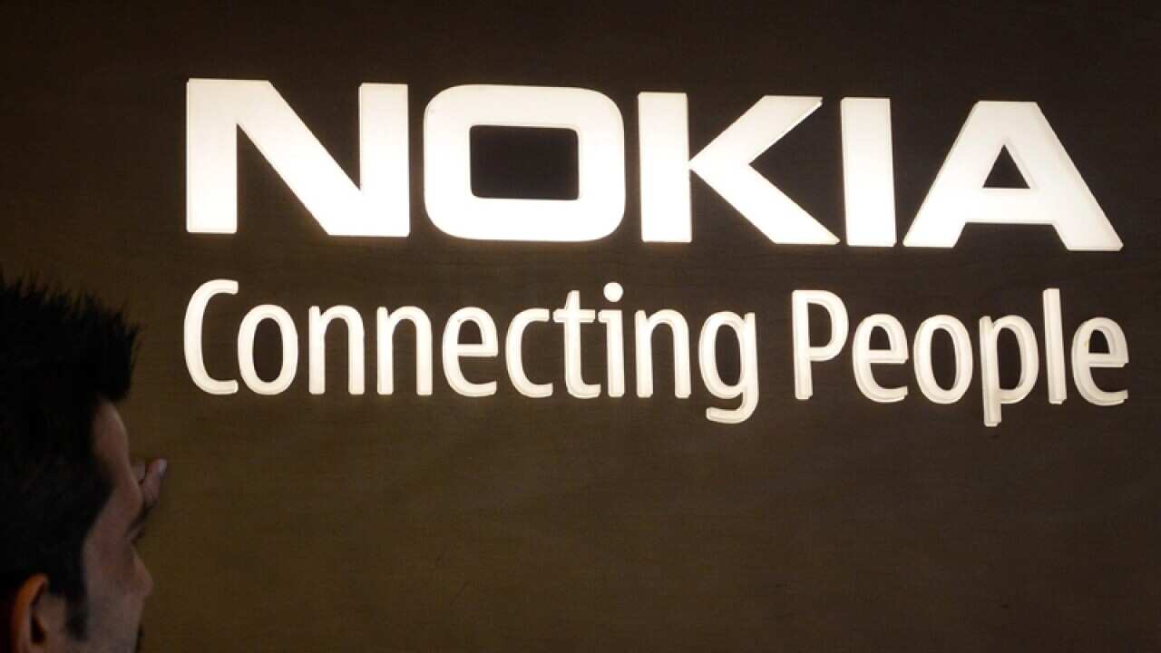 A customer looks at the Nokia logo inside a Nokia store, India