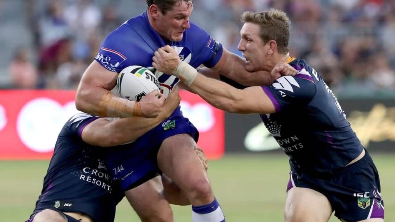 Joshua Jackson of the Bulldogs is tackled.