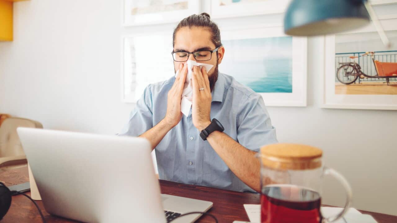Man sneezing, thunderstorm asthma