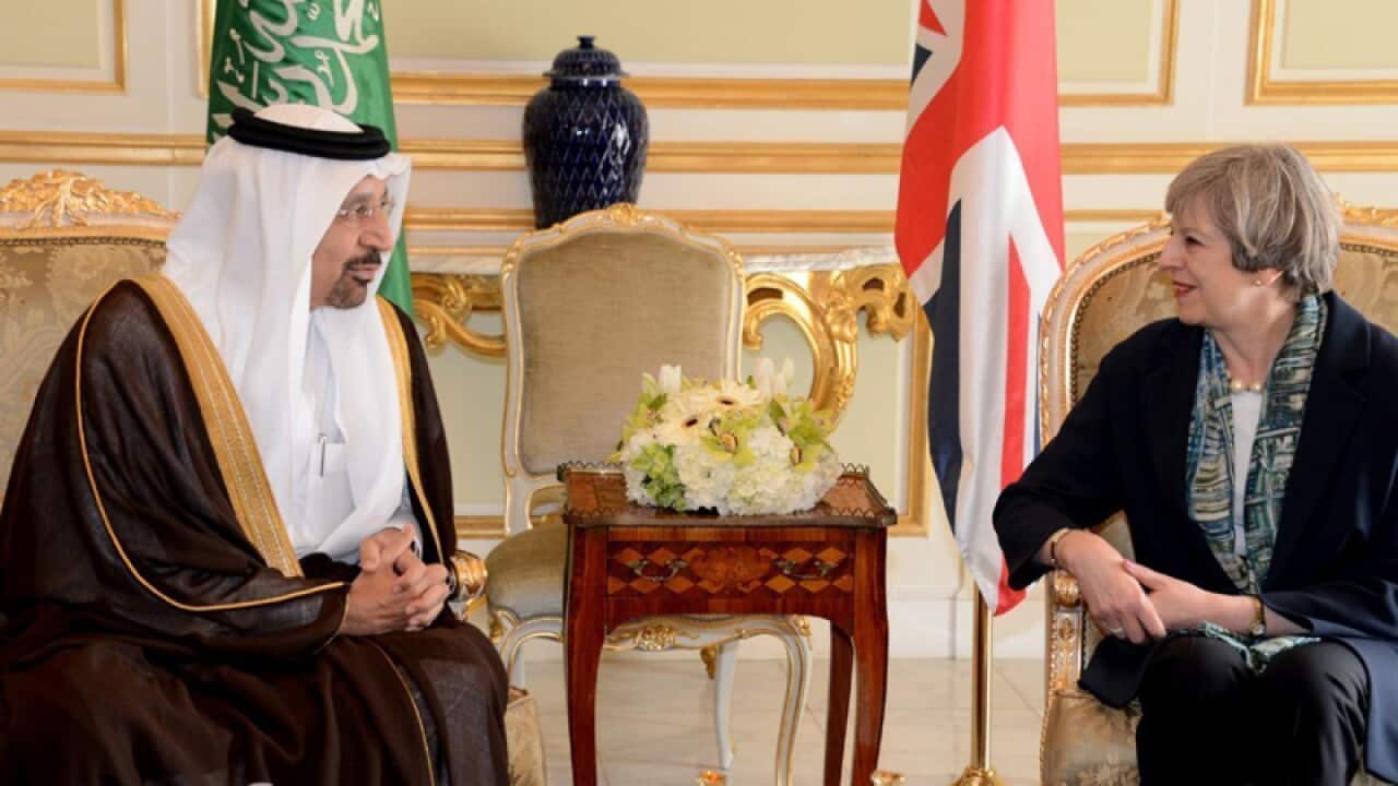 Saudi's Oil Minister Khalid al-Falih poses with British PM Theresa May