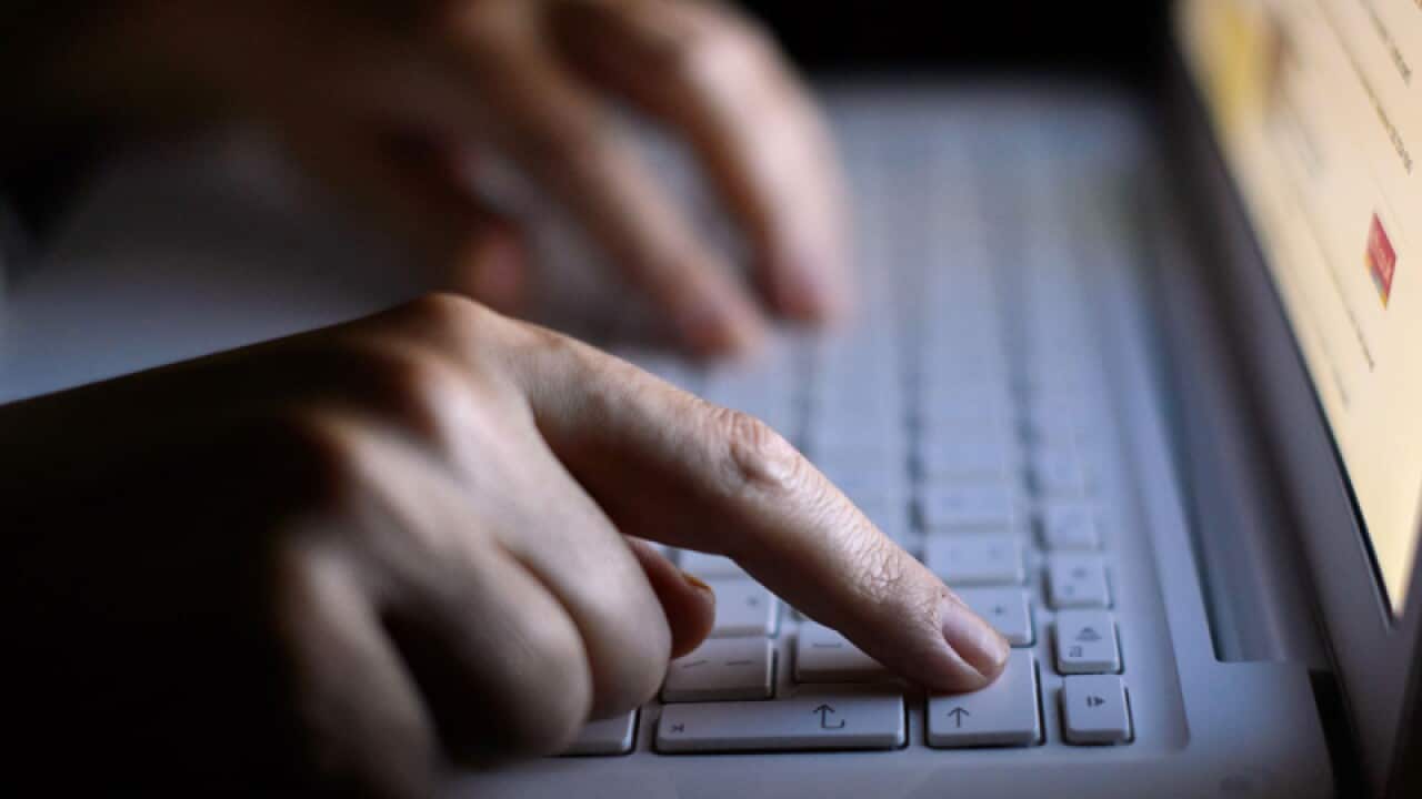 A woman's hands using a laptop keyboard