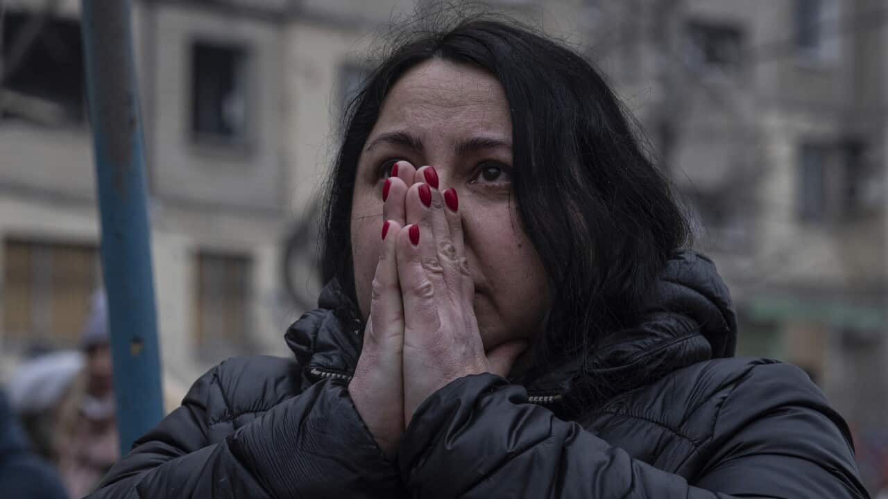 A woman reacts looking at the damage caused to an apartment building that was destroyed in a Russian rocket attack at a residential neighbourhood in the southeastern city of Dnipro, Ukraine, Sunday, Jan. 15, 2023.