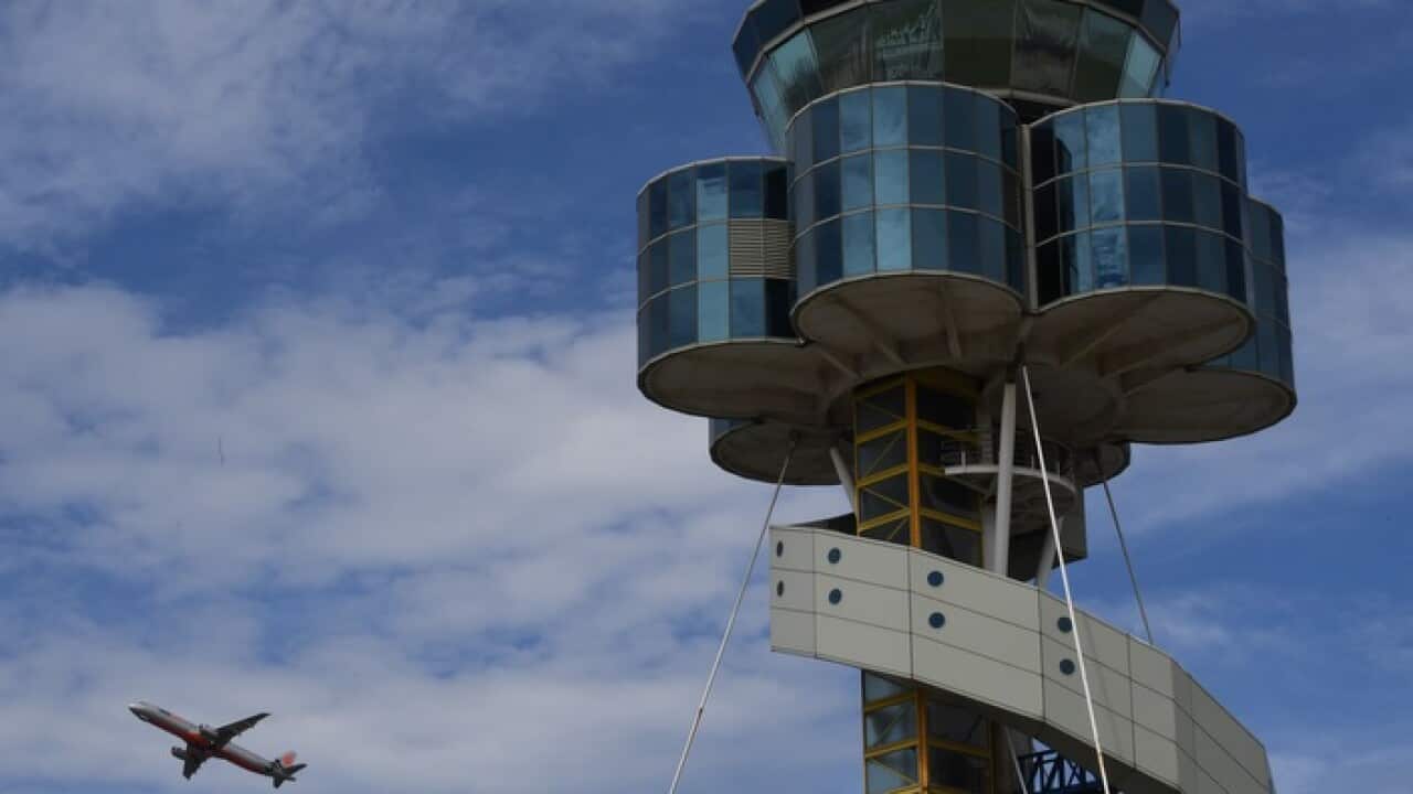 The control tower at Sydney Airport is seen as a plane takes off in Sydney.