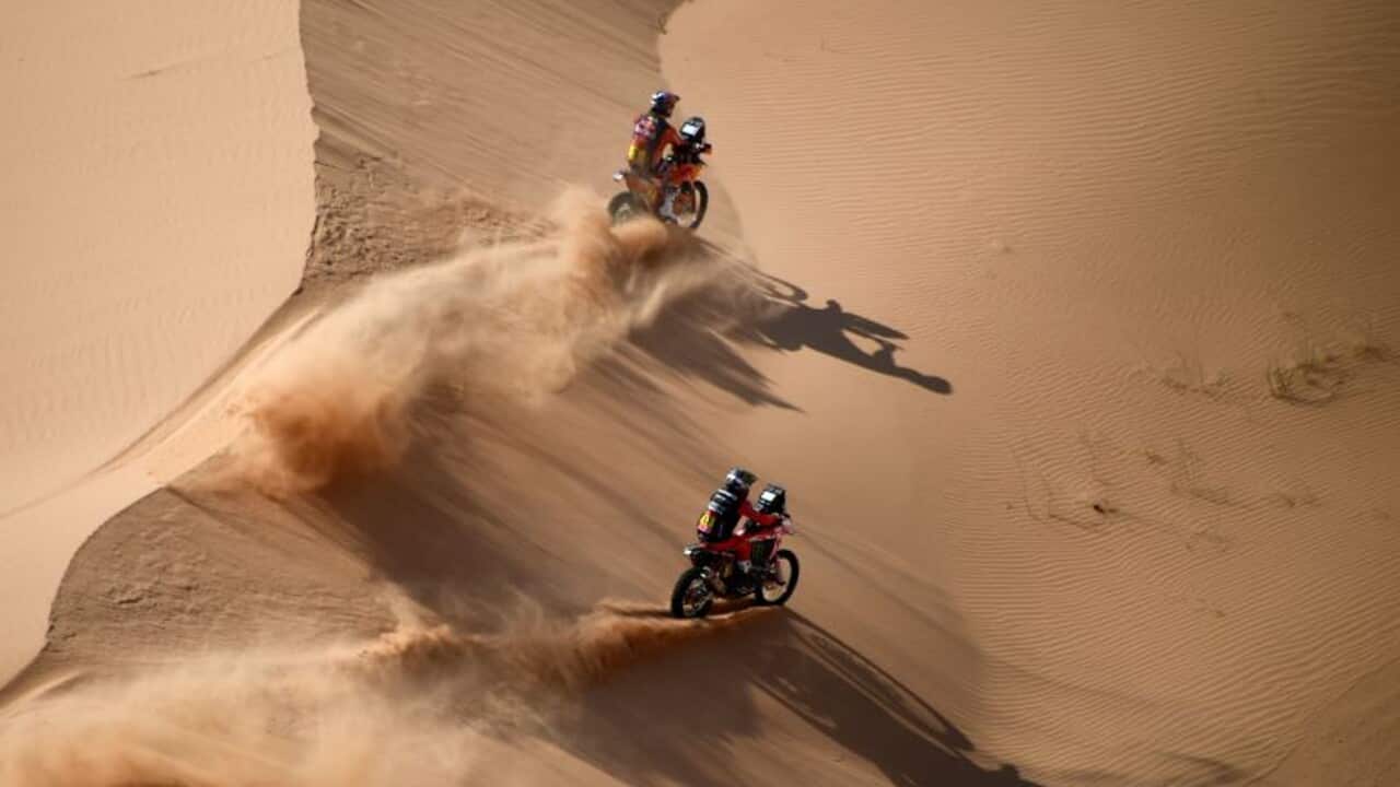 Toby Price and Kevin Benavides compete during a stage at the Dakar Rally.