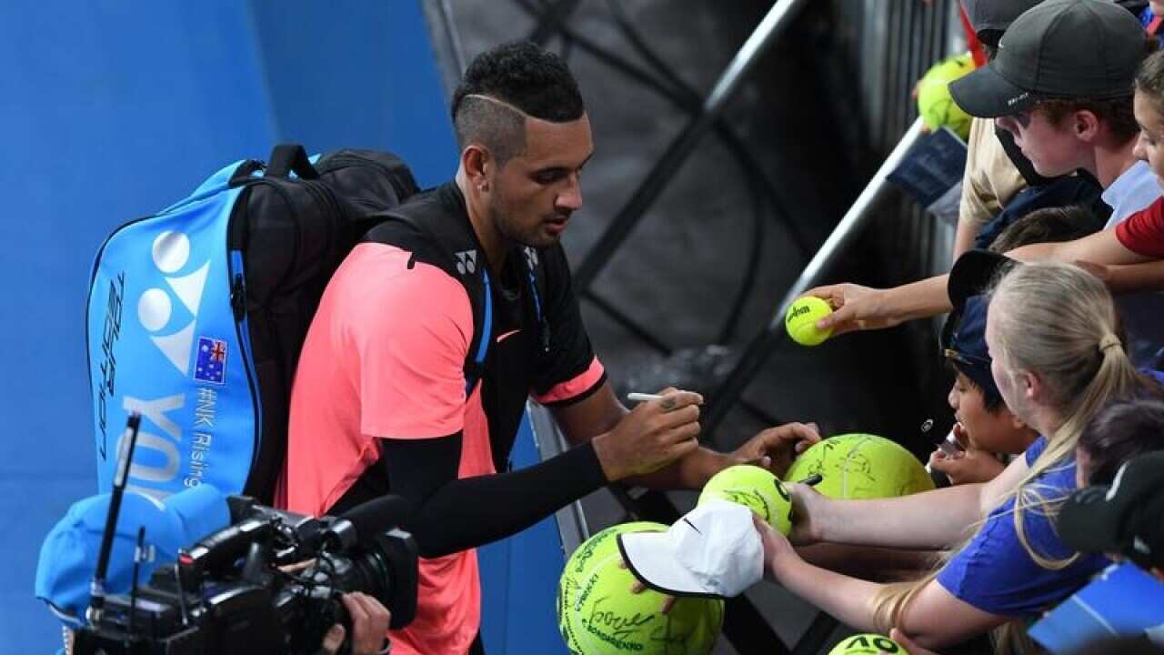 Nick Kyrgios of Australia signs autographs.
