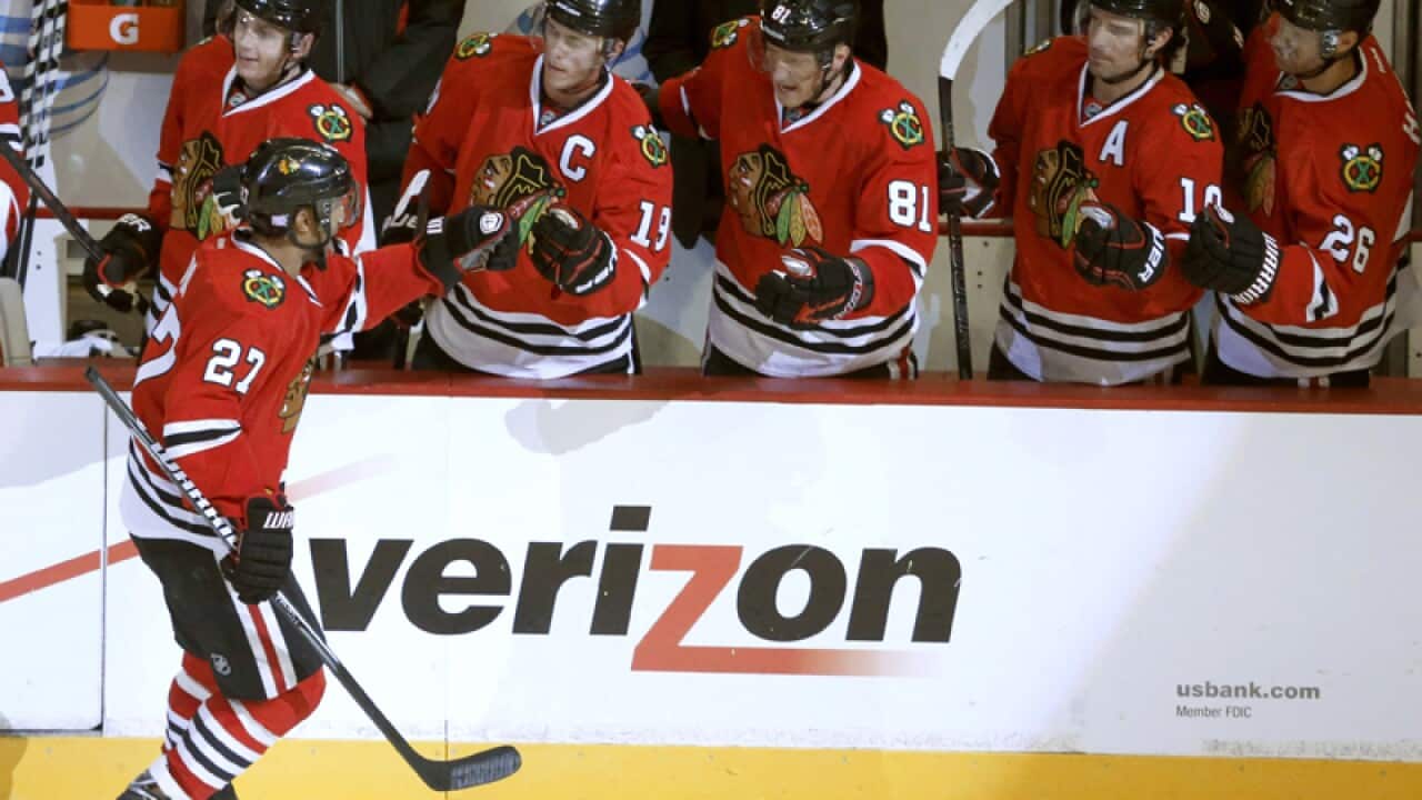 Chicago Blackhawks defenseman Johnny Oduya (L) celebrates his goal