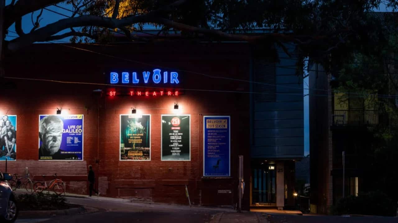 Exterior of Belvoir St Theatre in Surry Hills, New South Wales with neon lights and theatre posters at night.