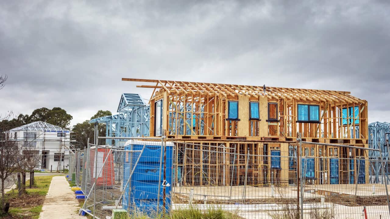 New houses timber construction frame, overcast sky, housing development