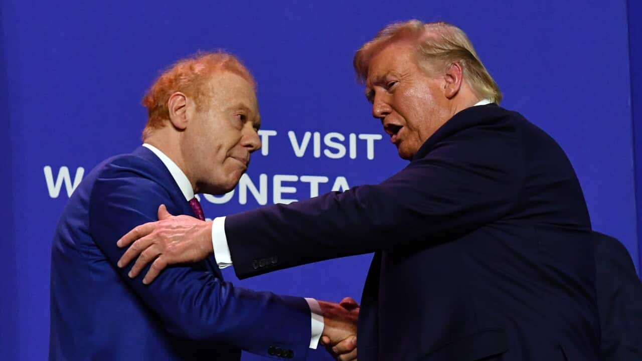 Two men wearing suits shaking hands
