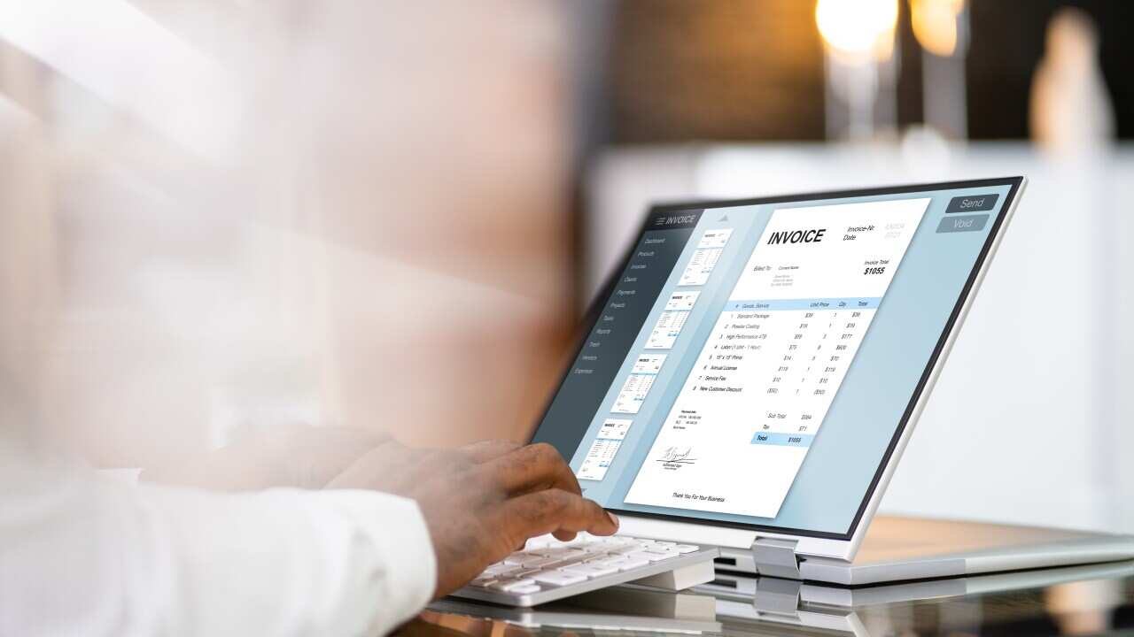 A person looking at an online invoice on a laptop