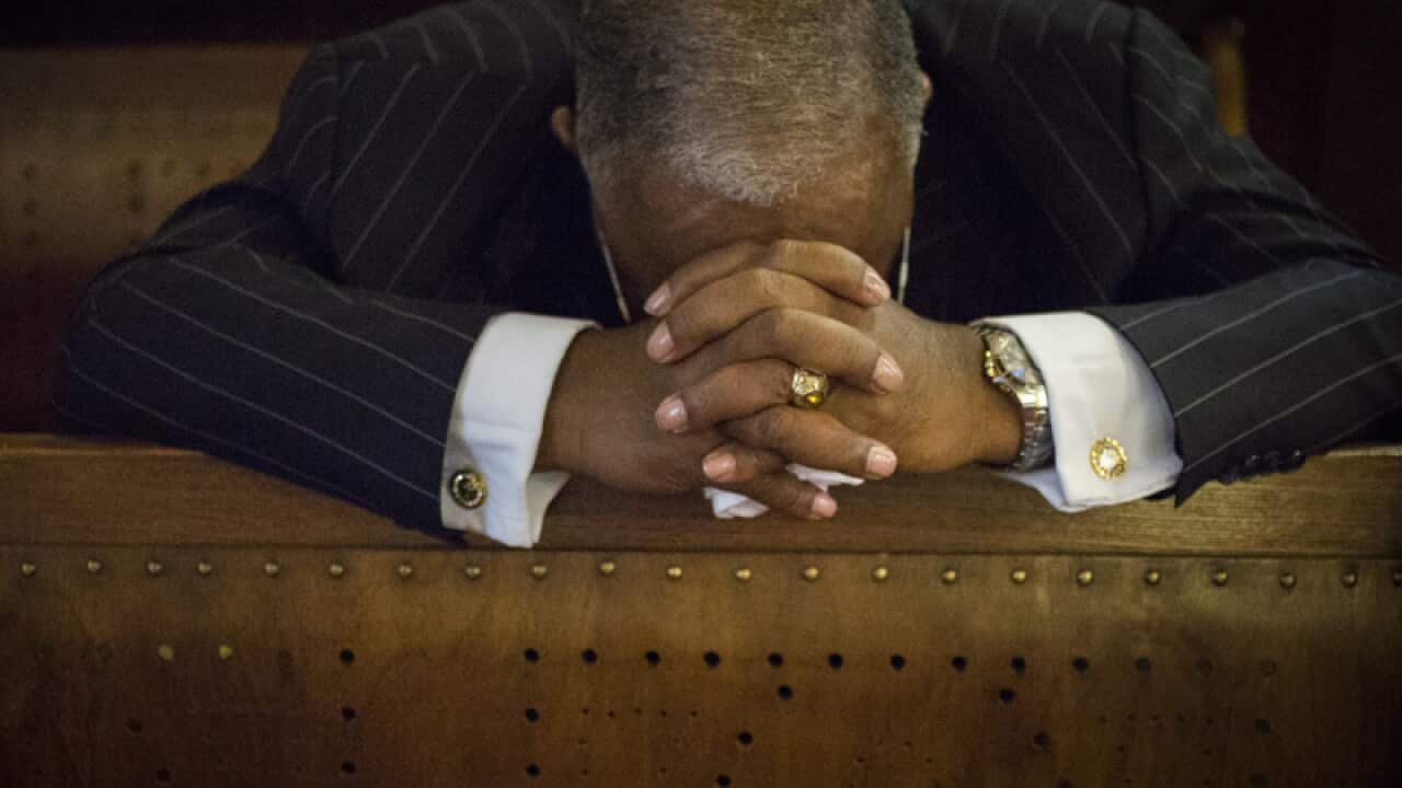 A man prays during a prayer vigil