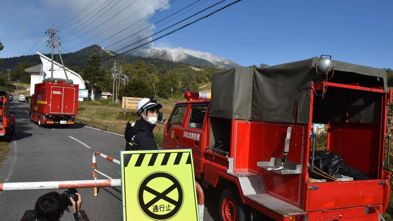 Japan volcano eruption: Fire department vehicles enter a road leading to the mountain trail of Mount Ontake in Nagano prefecture.