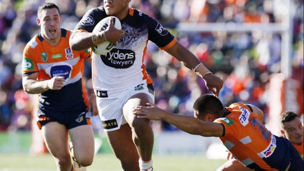 Moses Suli of the Tigers busts through the Knights defence