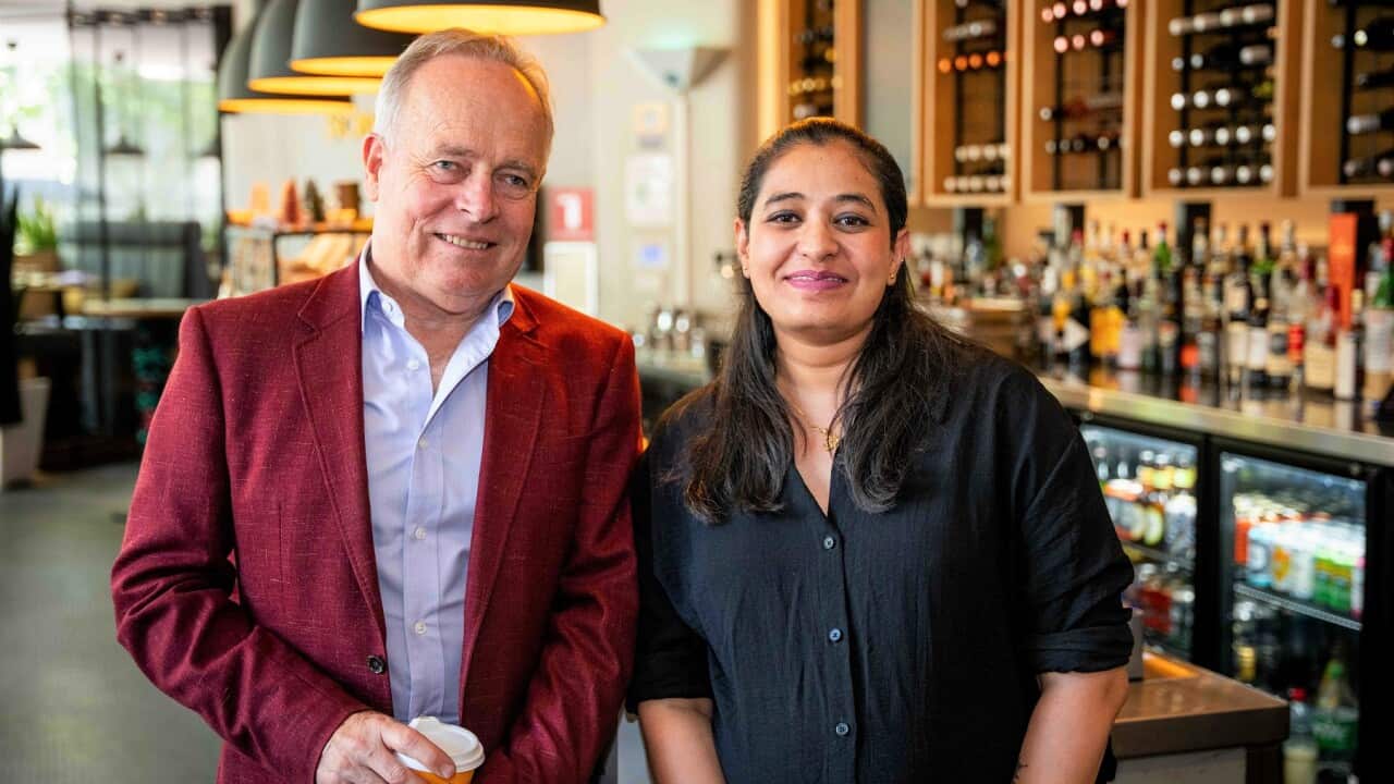 Song Hotel general manager Jon Ackary (left) with YWCA's Pooja (SBS).jpg