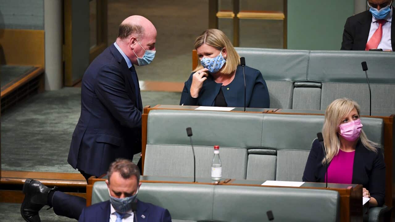 Liberal member for Bass Bridget Archer (right) speaks to Liberal MP Trent Zimmerman during House of Representatives Question Time at Parliament House in Canberra, Thursday, November 25, 2021. (AAP Image/Lukas Coch) NO ARCHIVING