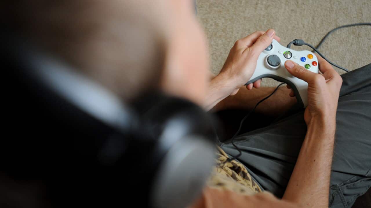 A man plays an XBox video